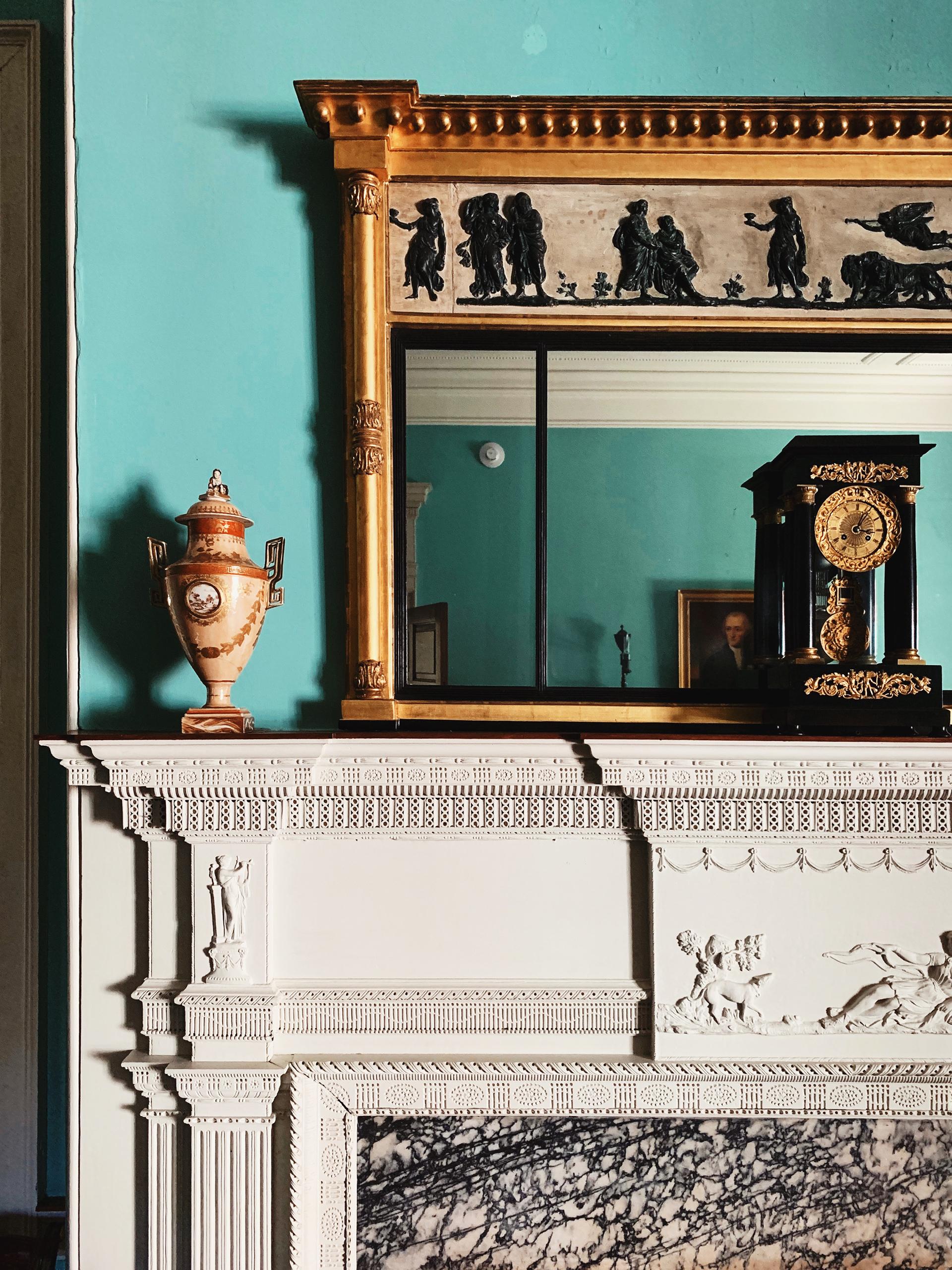 Composite Ornamentation on the fireplace mantel with a looking glass above