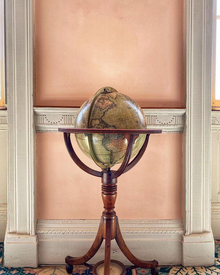 Terrestrial globe against a wall and between two windows